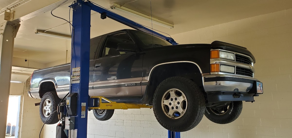 A truck up on the lift inside the Platinum Auto Repair shop in Ogden